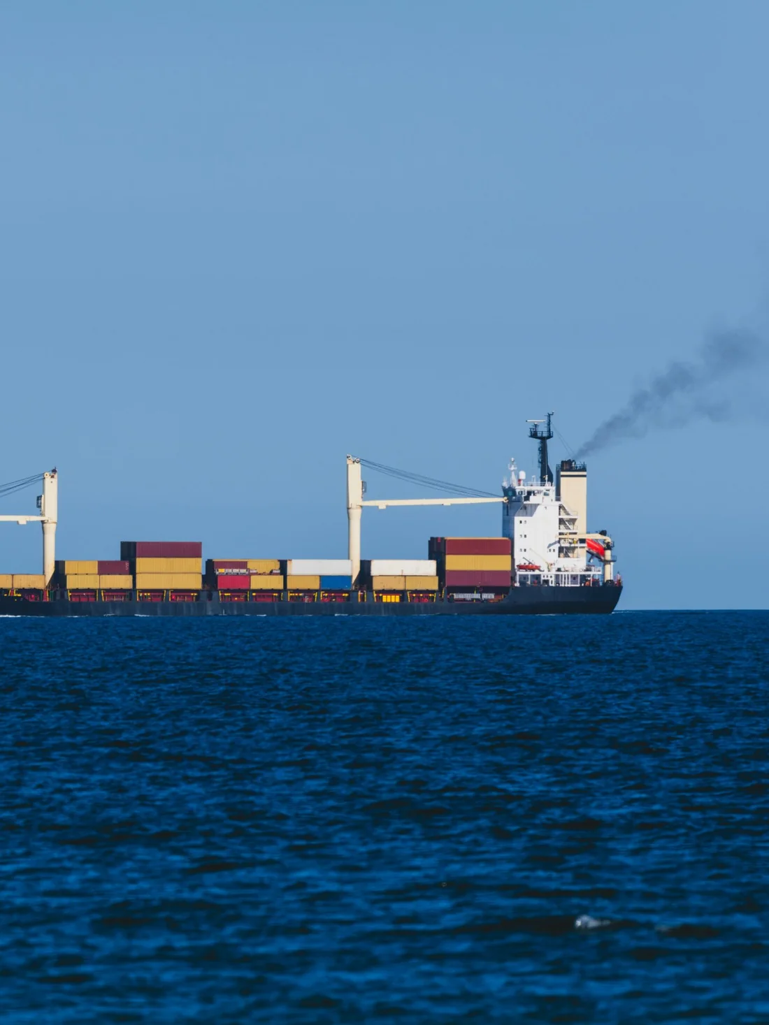 Container ship sailing on open sea at sea